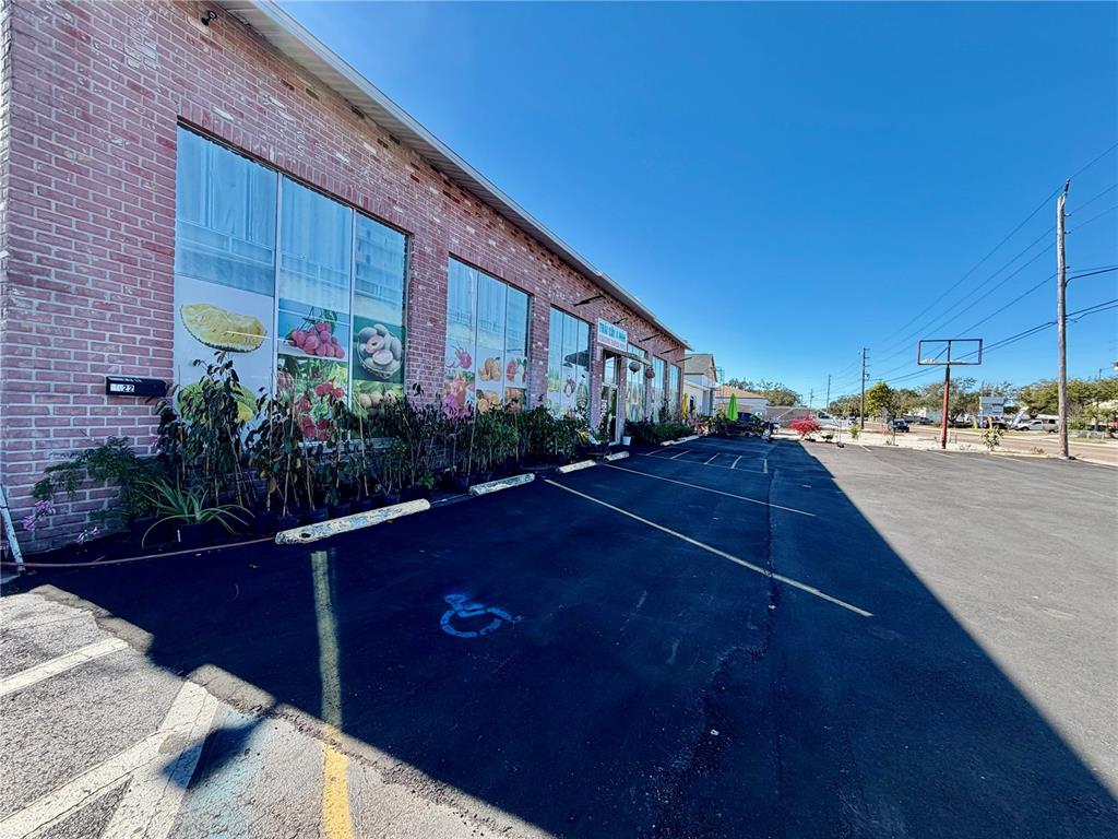 A brick commercial building with large glass windows and a paved parking lot — 4022 54TH AVENUE N, ST PETERSBURG, FL
