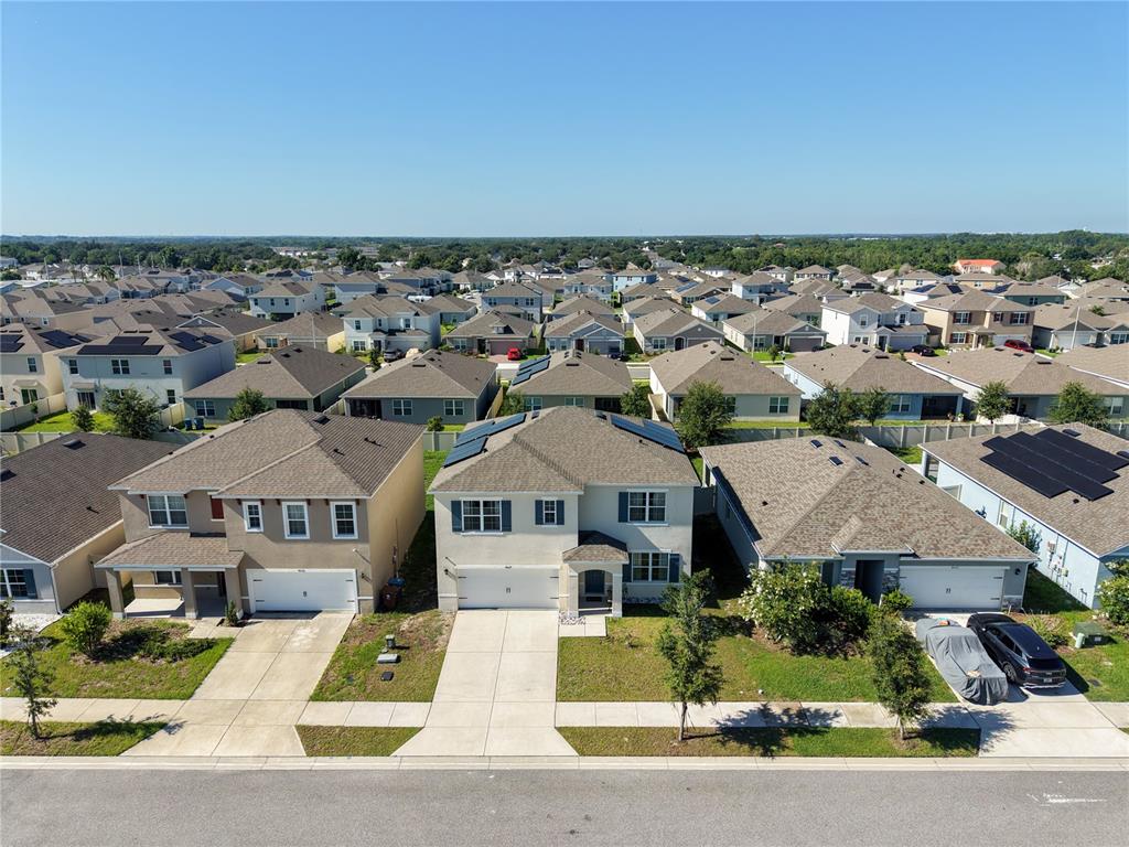 An aerial view shows a suburban neighborhood with several two-story houses and paved driveways — 4027 ALISSA LANE, HAINES CITY, FL
