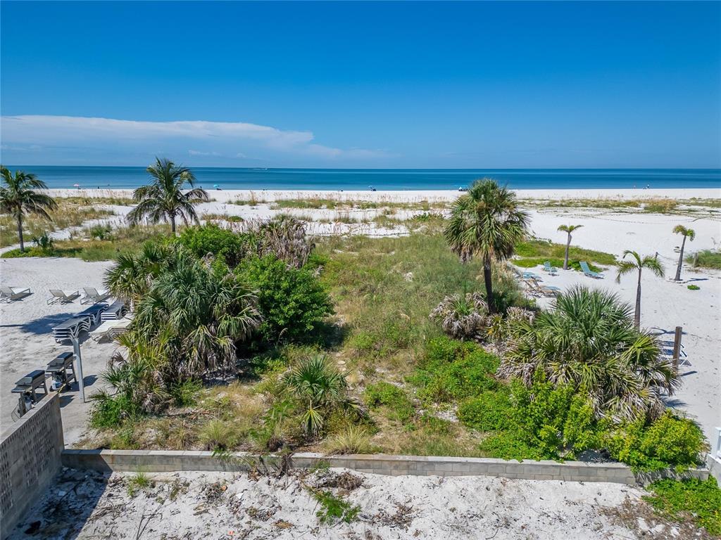An elevated view of a sandy beach with palm trees and native vegetation — 10178 GULF BOULEVARD, TREASURE ISLAND, FL