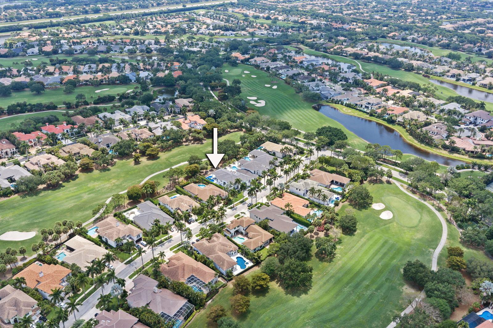 An aerial view shows a residential neighborhood with houses, swimming pools, and a golf course — 16014 Laurel Creek Drive, Delray Beach FL 33446, DELRAY BEACH, FL
