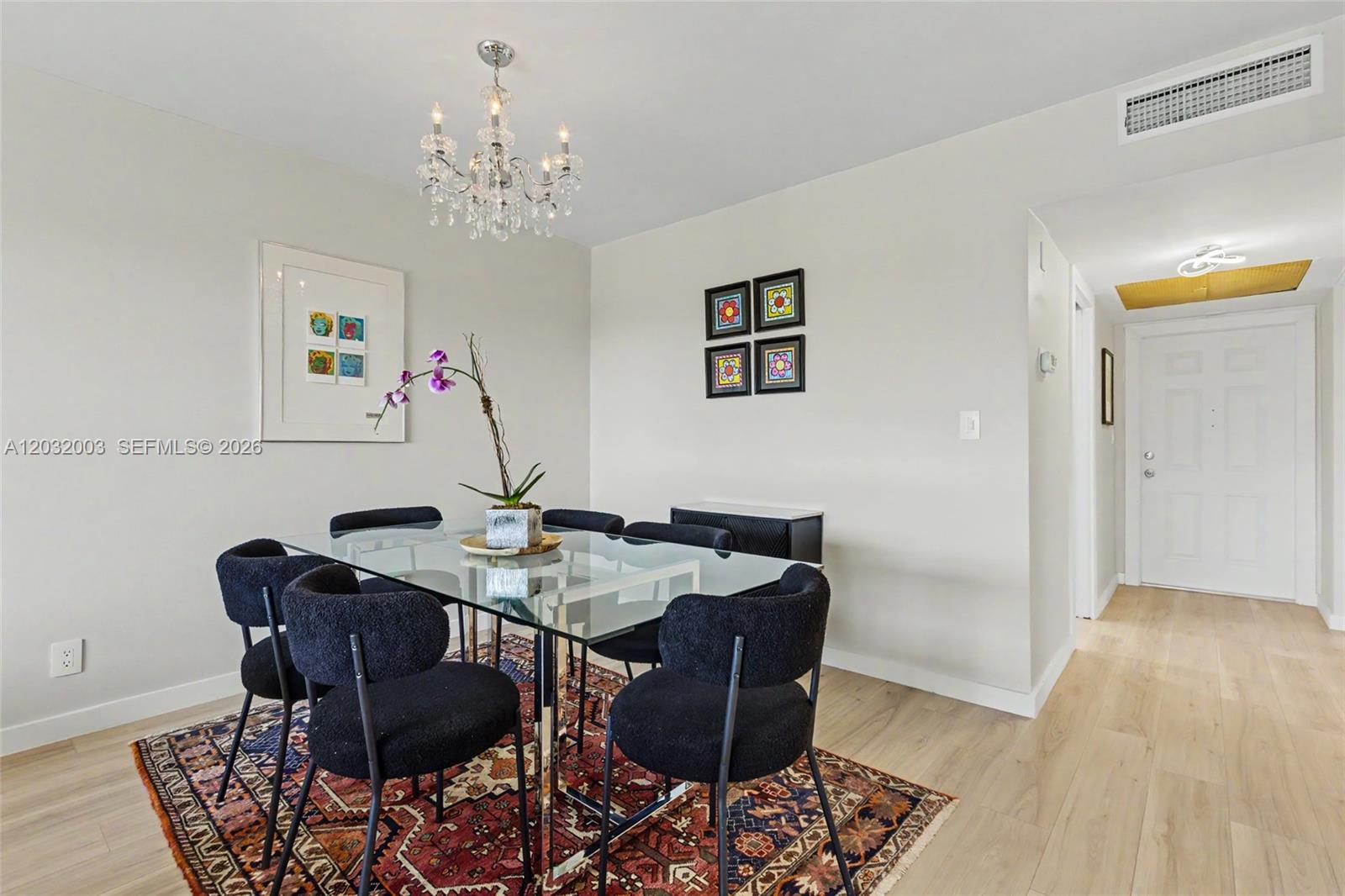 A dining and living area features a glass table, dark chairs, and a patterned rug — 3150 N Palm Aire Dr # 705, Pompano Beach FL 33069, POMPANO BEACH, FL