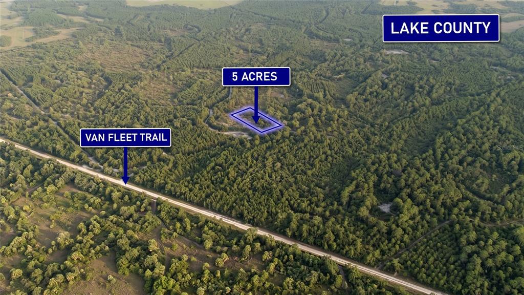 An aerial view shows a five-acre plot of wooded land near the Van Fleet Trail — 0000 CALVIN LEE ROAD, CLERMONT, FL