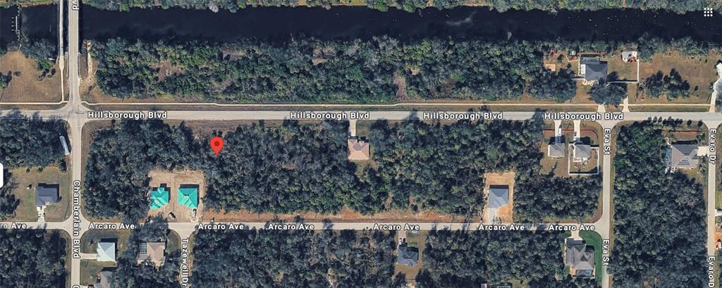 This aerial map shows a wooded residential lot located between Hillsborough Boulevard and Arcaro Avenue — 16213 HILLSBOROUGH BOULEVARD, PORT CHARLOTTE, FL