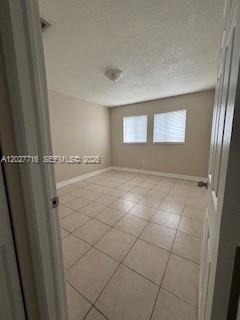 An empty room with light-colored tile flooring and two windows with white blinds — 5694 W 25th Ct # 5694, Hialeah FL 33016, HIALEAH, FL
