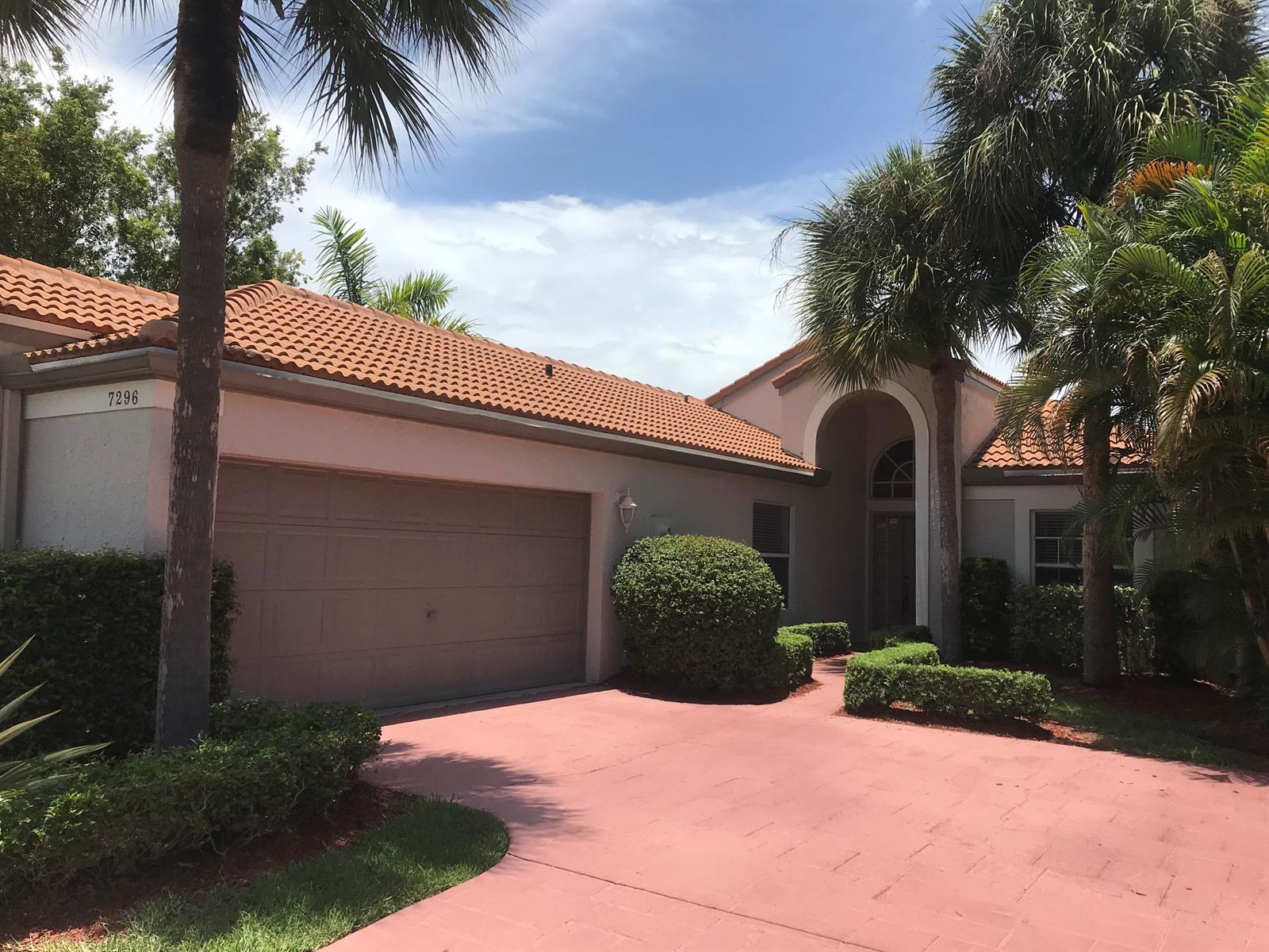 A single-story house with a terracotta tile roof, a garage, and palm trees — 7296 Via Palomar, Boca Raton FL 33433, BOCA RATON, FL