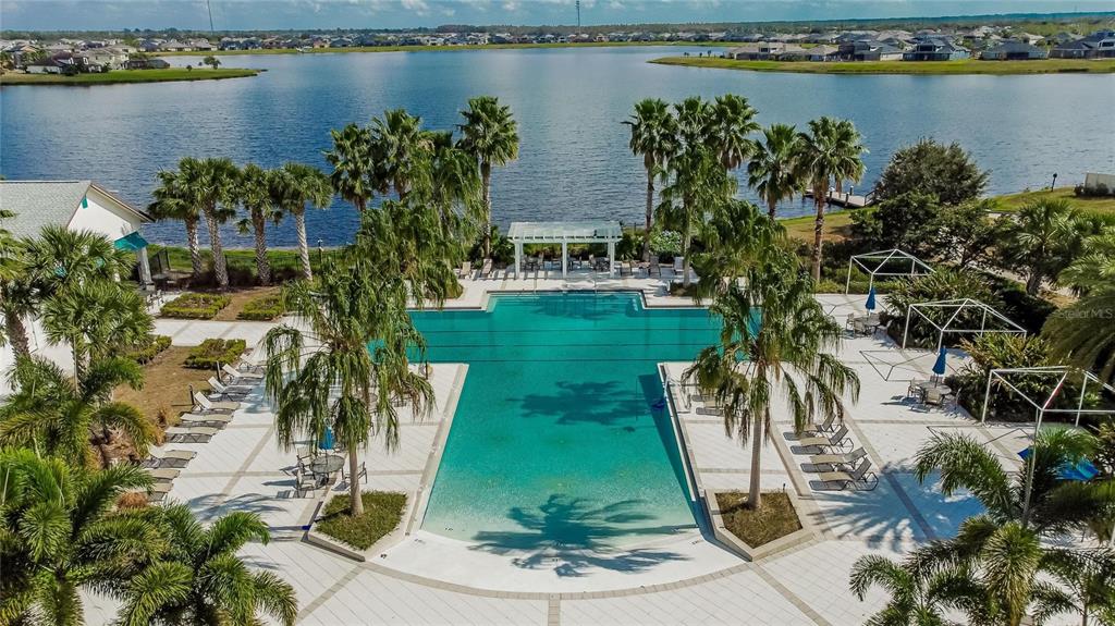 A two-story house with a brick paver driveway, two garage doors, and two palm trees — 11628 LAKE LUCAYA DRIVE, RIVERVIEW, FL