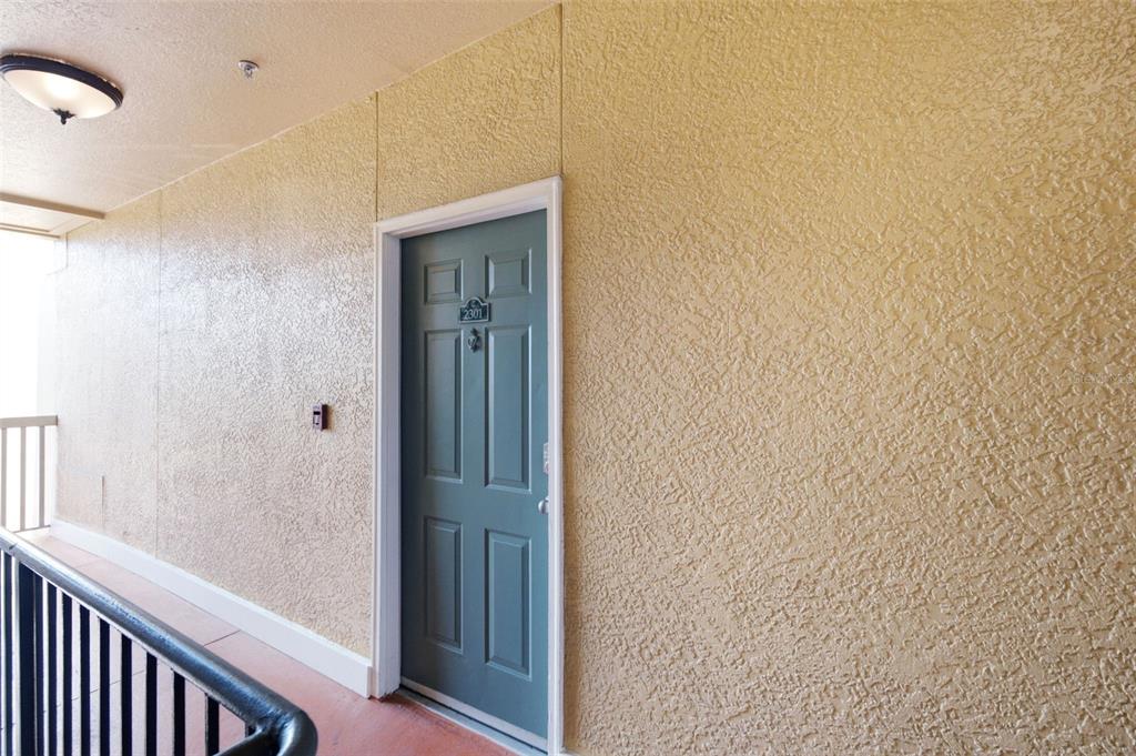 A living room with a sofa, coffee table, armchairs, and a desk in an alcove — 4207 S DALE MABRY HIGHWAY UNIT 2301, TAMPA, FL