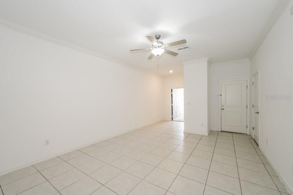 An empty room with white walls, tile flooring, and a ceiling fan — 2182 AZURE VIEW WAY, LUTZ, FL