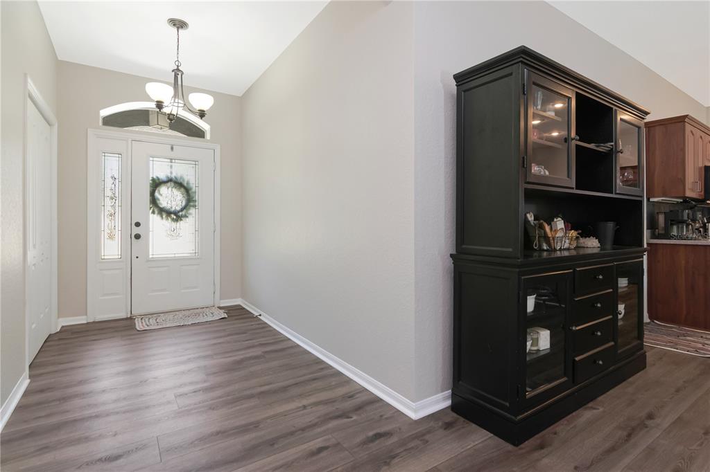 A foyer features wood-look flooring, a white front door with a transom window, and a hutch — 219 WILLOW BEND PARKWAY, LUTZ, FL