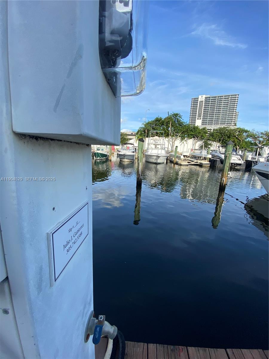 A boat slip at a marina with a nameplate and docked boats in the background — 1700 NW North River Dr. #51, Miami FL 33125, MIAMI, FL