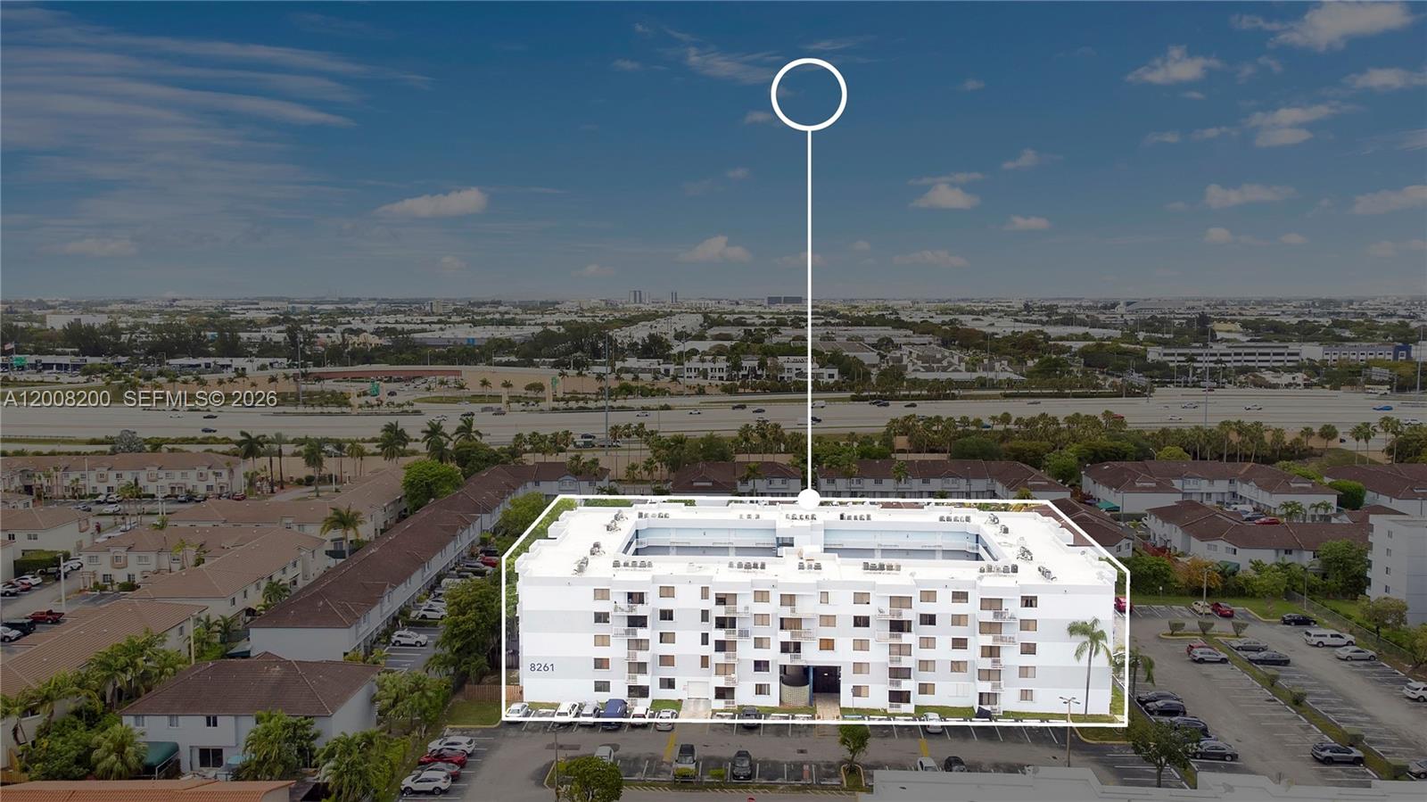An aerial view shows a multi-story white apartment building with a central courtyard and parking — 8261 NW 8th St # 231, Miami FL 33126, MIAMI, FL