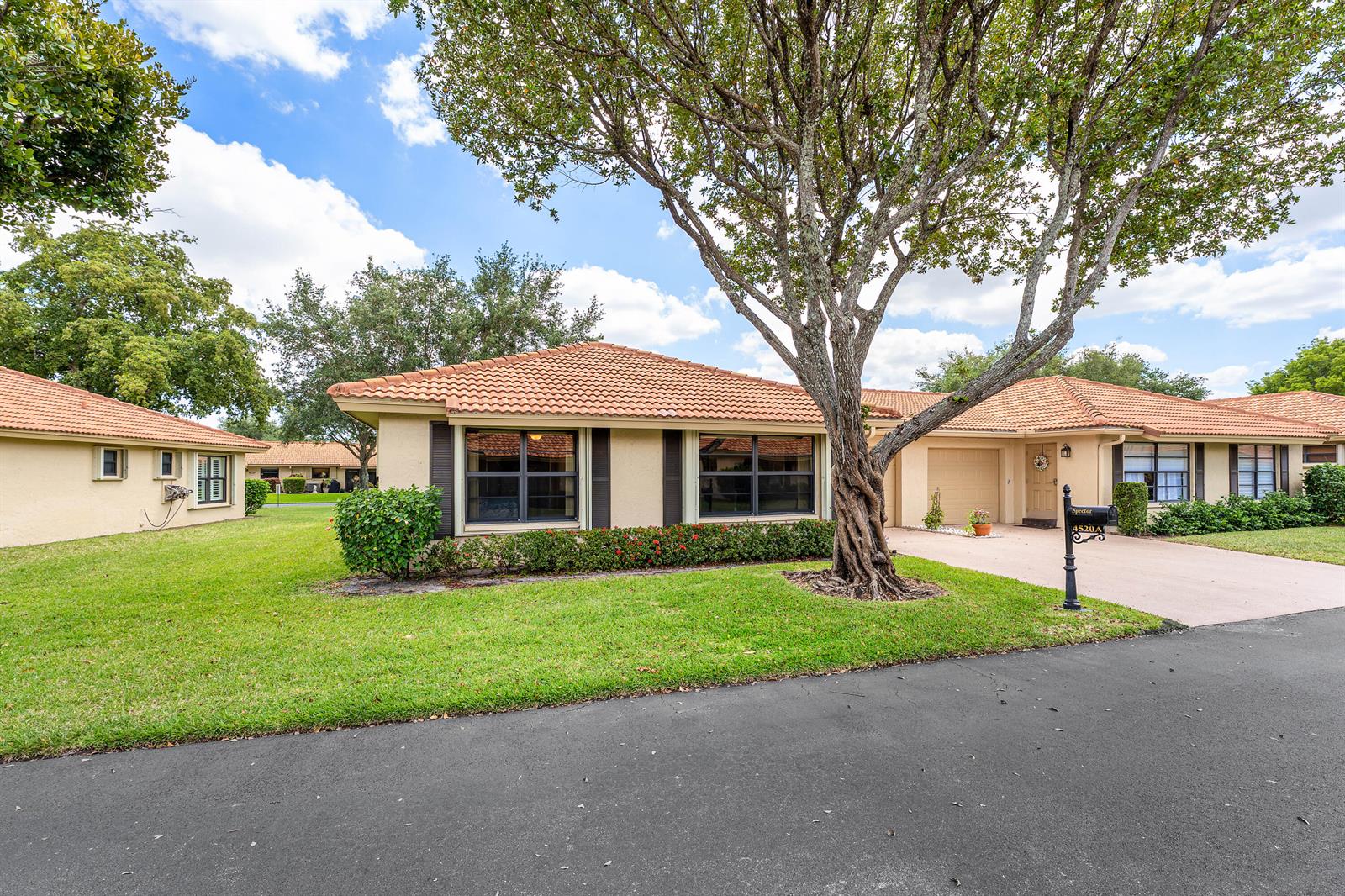 A single-story house with a tiled roof, a large tree, and a paved driveway — 4520 Ficus Tree Road, Boynton Beach FL 33436, BOYNTON BEACH, FL