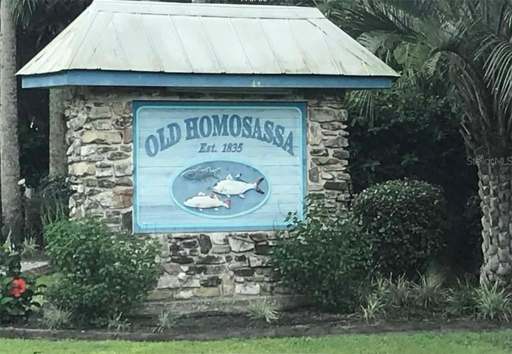 A stone monument sign with a metal roof welcomes visitors to Old Homosassa — 10863 W XANADU PATH, HOMOSASSA, FL