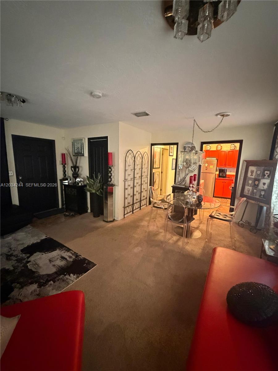 A dining area with a glass table and chairs sits adjacent to a bright kitchen — 16980 SW 104th Ave, Miami FL 33157, MIAMI, FL