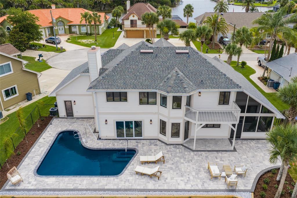 An aerial view of a two-story house with a swimming pool and a paved patio — 7 CHINOOK COURT, PALM COAST, FL
