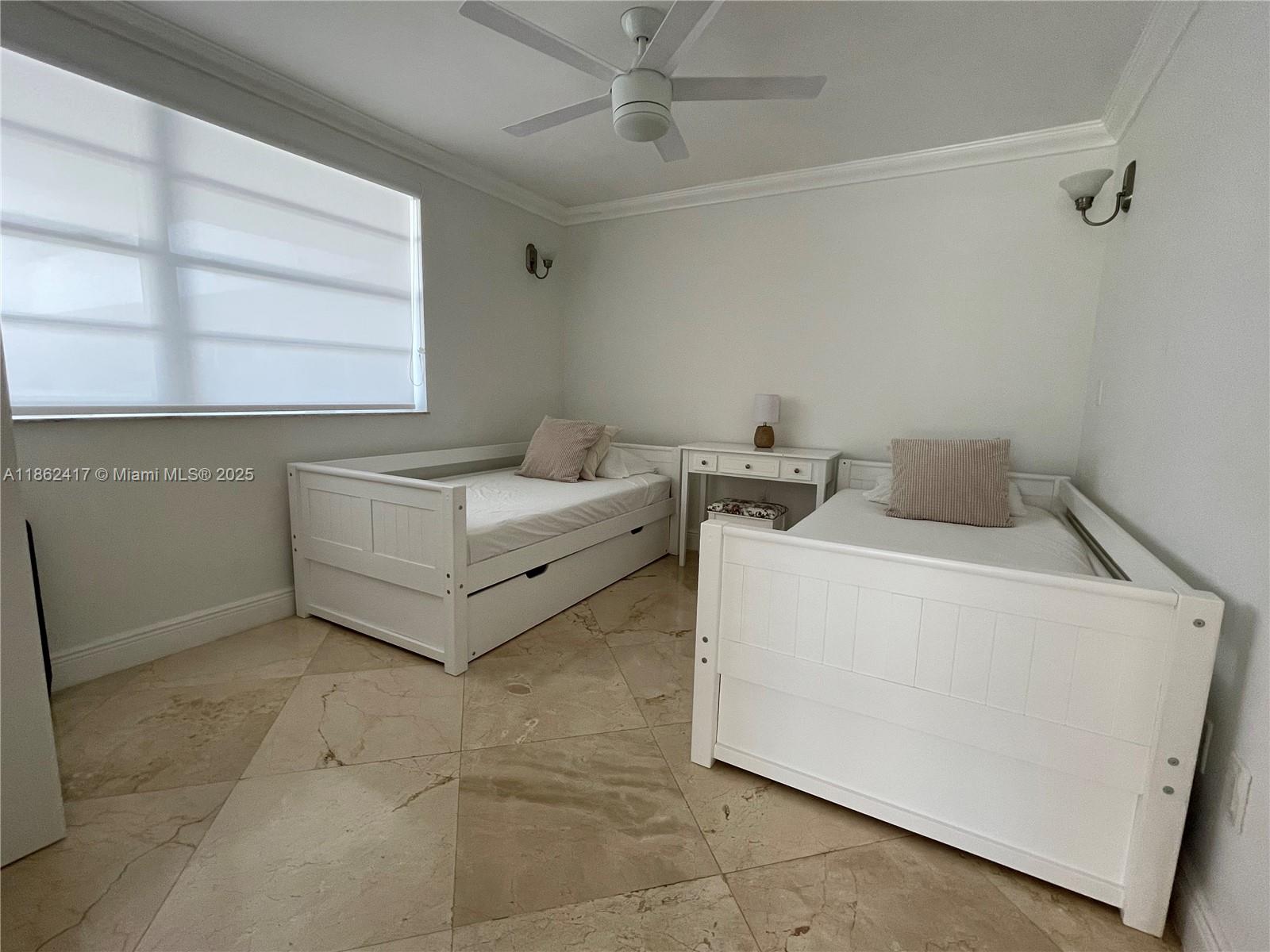 A bedroom features two white daybeds, a small desk, and light-colored tile flooring — 177 Ocean Lane Dr # 209, Key Biscayne FL 33149, KEY BISCAYNE, FL