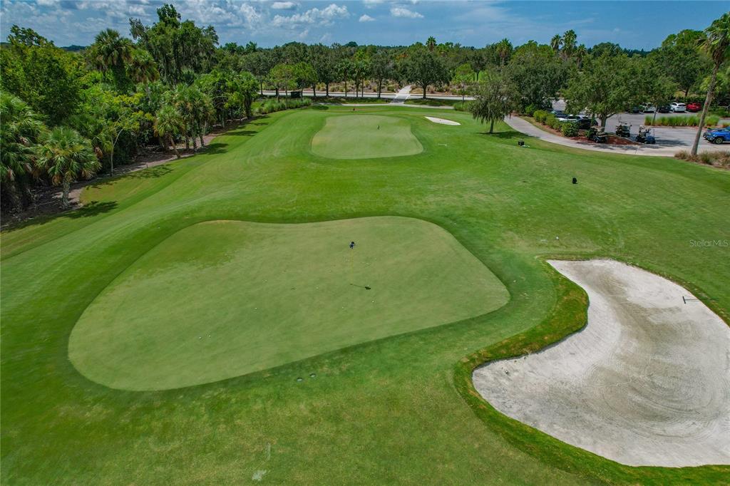 An aerial view of a golf course green with a sand bunker nearby — 8205 GRAND ESTUARY TRAIL UNIT 404, BRADENTON, FL