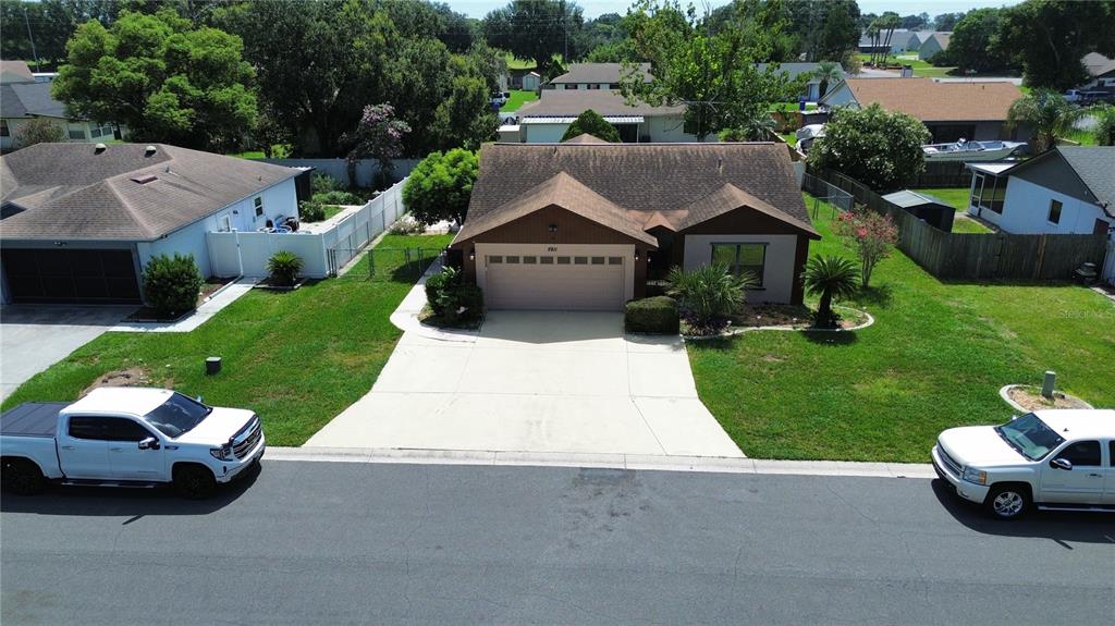 An aerial view of a single-story house with a two-car garage and driveway — 5911 N FORK COURT, LAKELAND, FL