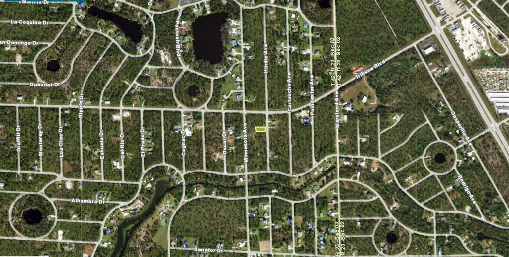 This is an aerial map showing a vacant lot highlighted in yellow within a residential neighborhood — 12291 HINDLE AVENUE, PUNTA GORDA, FL