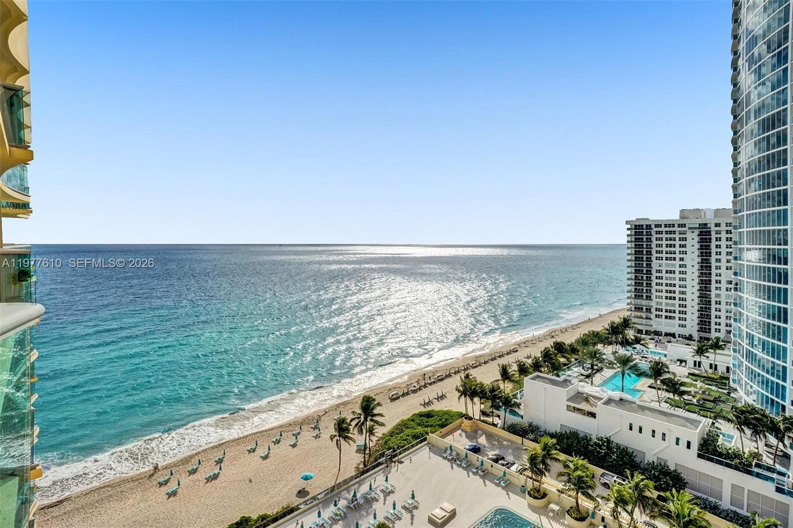 An elevated view of a sandy beach, ocean, and surrounding high-rise buildings — 2501 S Ocean Dr, Hollywood FL 33019, HOLLYWOOD, FL