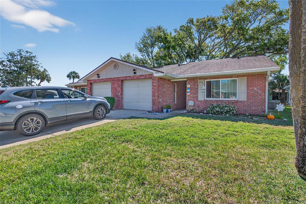 A single-story brick house with a two-car garage and a gray SUV in the driveway — 1402 PORTOBELLO DRIVE, PORT ORANGE, FL