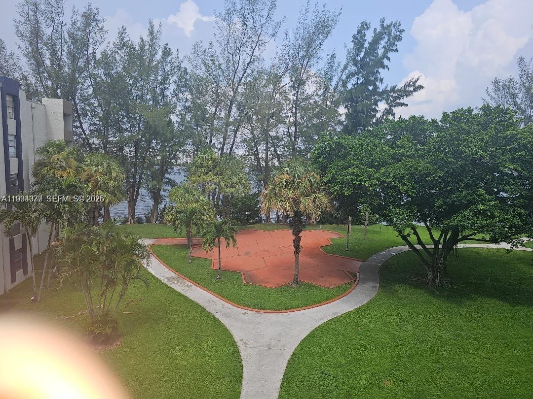 An elevated view shows a grassy courtyard with a paved path and a hexagonal patio — 10000 NW 80th Ct # 2415, Hialeah Gardens FL 33016, HIALEAH GARDENS, FL