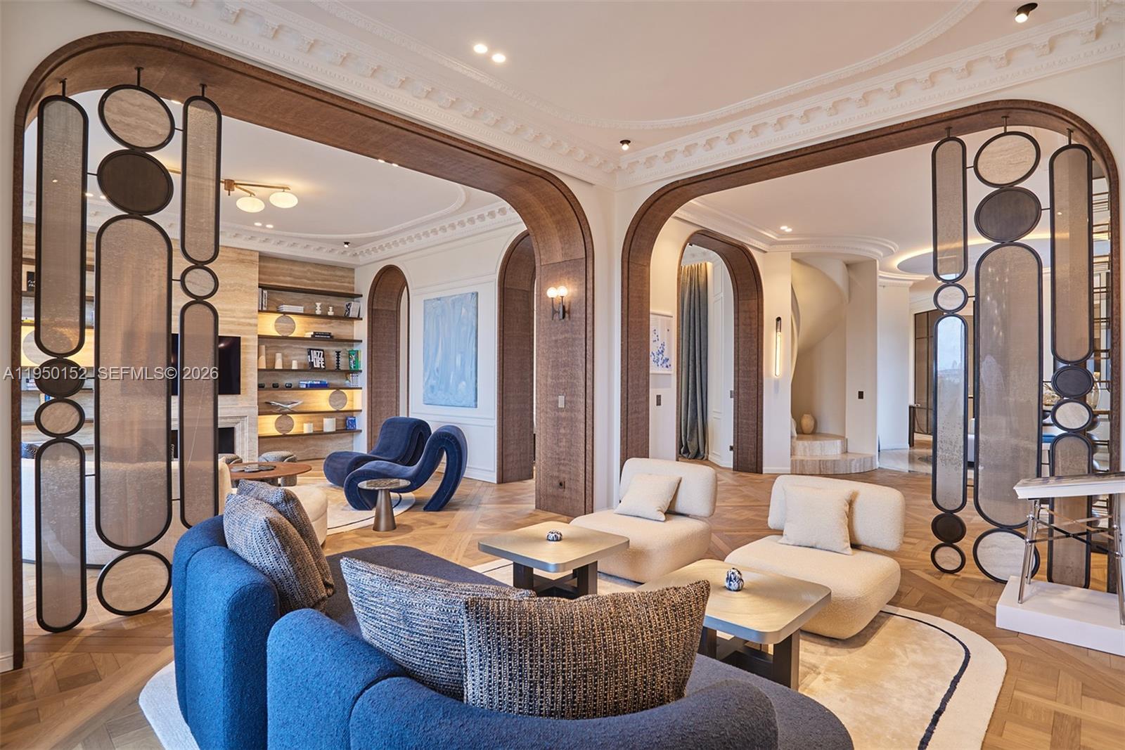 A living room features arched wooden doorways, decorative room dividers, and modern blue and cream furniture — 48 AVENUE GEORGES MANDEL, FR, FR