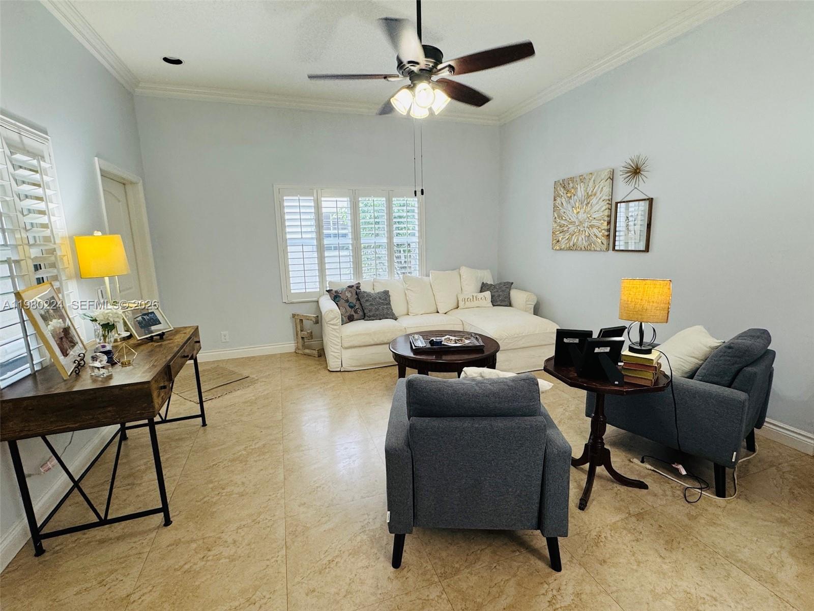 A living room features a white sectional sofa, two blue armchairs, and a wooden desk — 4321 Willow Ridge Dr, Weston FL 33331, WESTON, FL