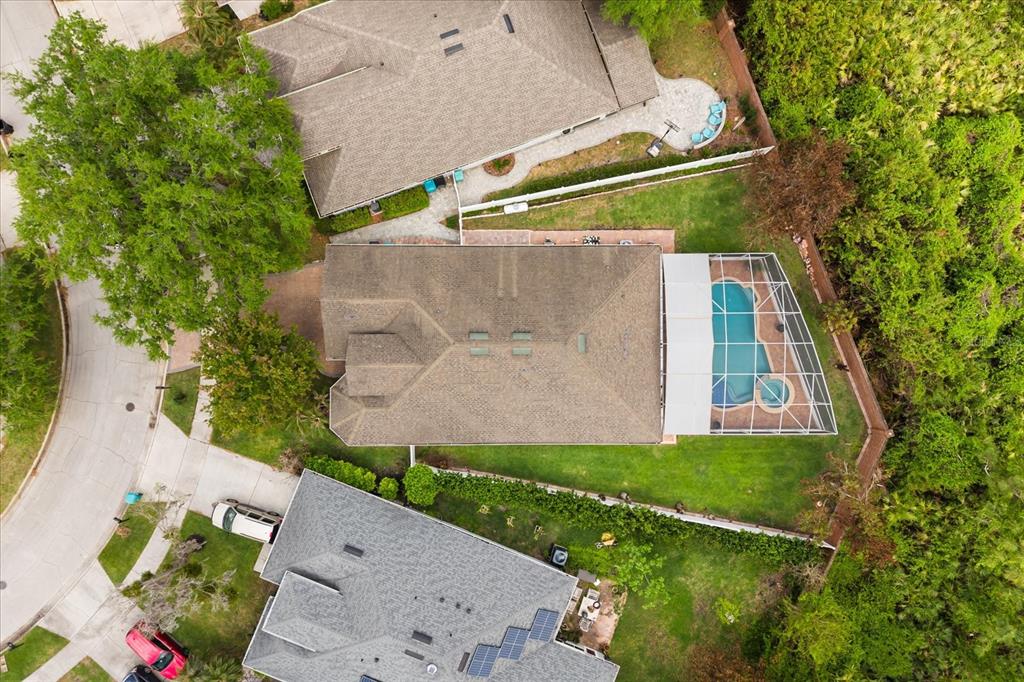 An aerial view shows a house with a screened-in pool and a fenced backyard — 10180 CYPRESS VINE DRIVE, ORLANDO, FL