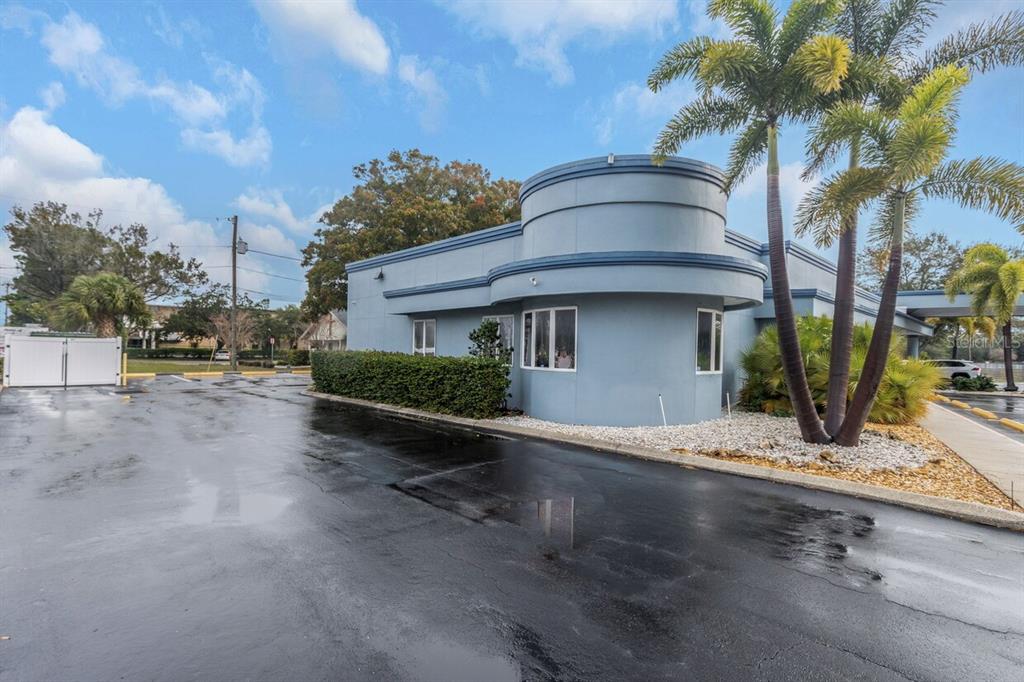 A blue commercial building with a curved corner section and a parking lot — 7641 66TH STREET N, PINELLAS PARK, FL