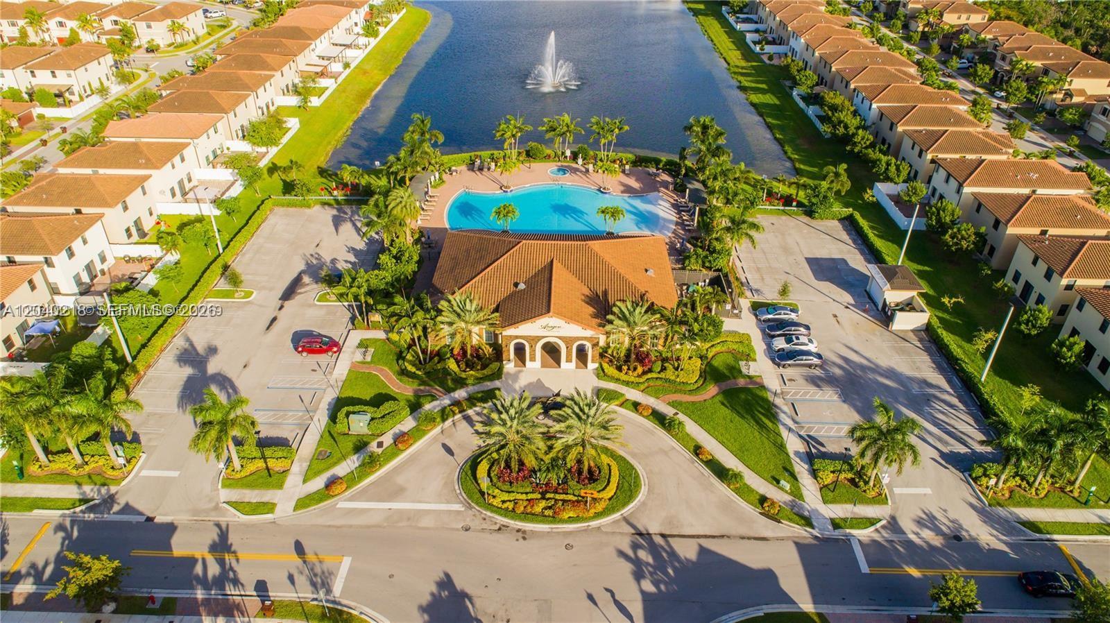 An aerial view shows a community clubhouse with a pool, fountain, and surrounding residential buildings — 9073 W 33rd Ave, Hialeah FL 33018, HIALEAH, FL