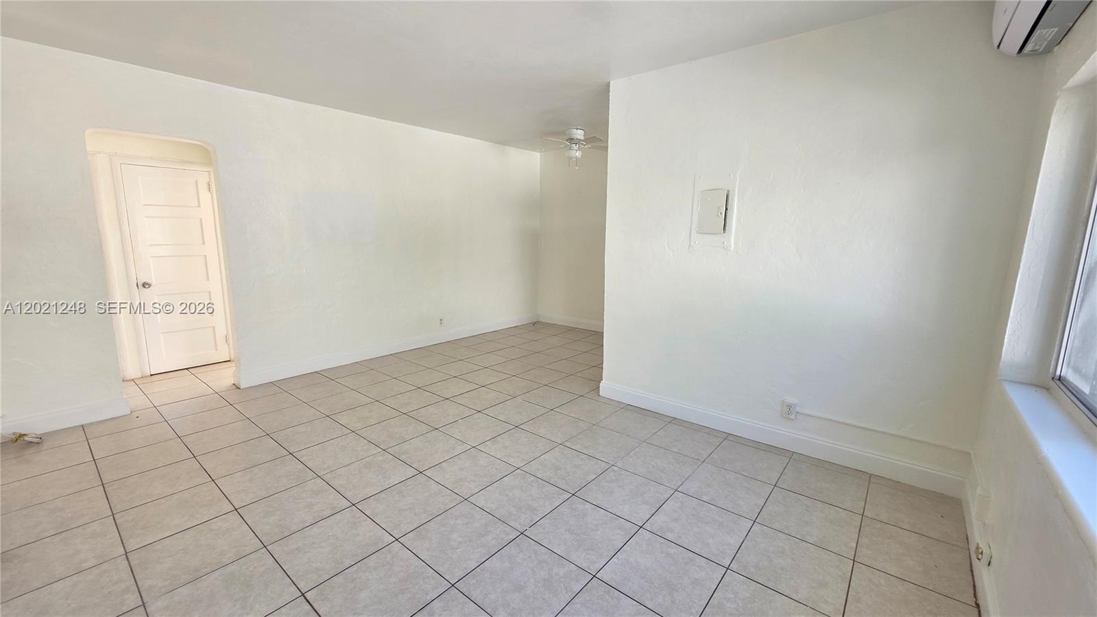 An empty room features white walls, light-colored floor tiles, and a ceiling fan — 7629 Dickens Ave # 7, Miami Beach FL 33141, MIAMI BEACH, FL