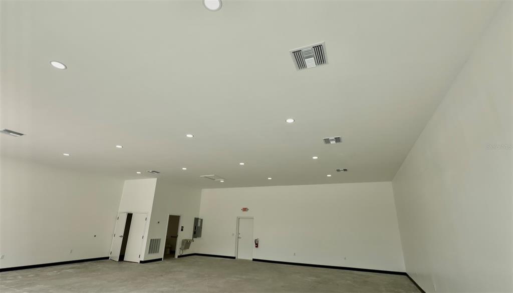 A spacious, unfinished room with white walls, a concrete floor, and recessed ceiling lighting — 727 TILLMAN PLACE UNIT 102, PLANT CITY, FL