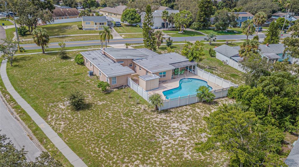 An aerial view shows a single-story house with a fenced backyard and a swimming pool — 912 RIVERSIDE DRIVE, TARPON SPRINGS, FL