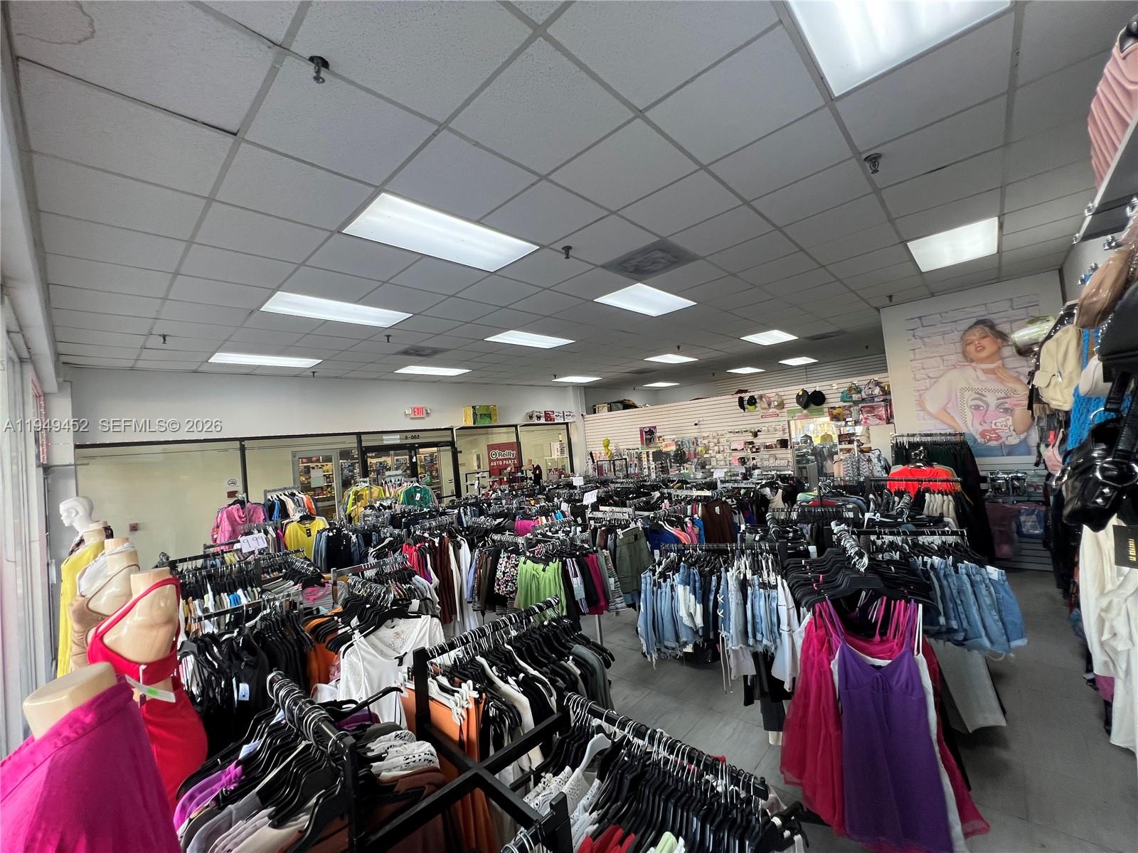 A retail clothing store features rows of garment racks, mannequins, and a drop ceiling — 500 W 49th St, Hialeah FL 33012, HIALEAH, FL