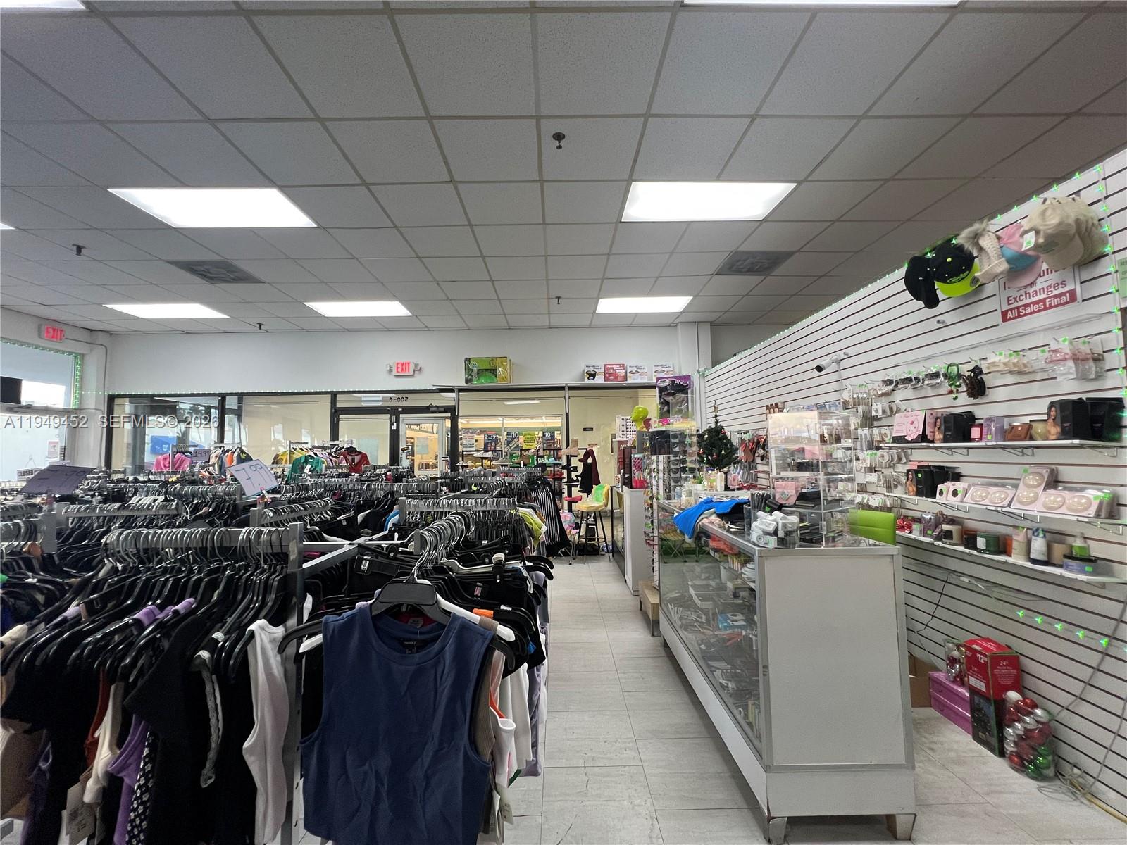 A retail store interior features clothing racks, a glass display counter, and wall-mounted shelving — 500 W 49th St, Hialeah FL 33012, HIALEAH, FL