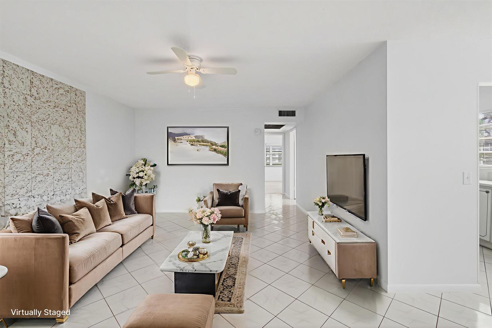 A living room features a beige sofa, marble-topped coffee table, and a wall-mounted television — 360 Fanshaw I, Boca Raton FL 33434, BOCA RATON, FL