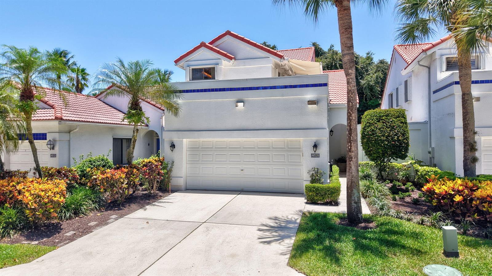A two-story house with a white stucco exterior, a tiled roof, and a two-car garage — 21692 Cromwell Circle, Boca Raton FL 33486, BOCA RATON, FL