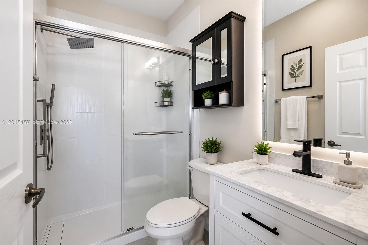 A modern bathroom features a glass-enclosed shower, a white vanity with marble top, and toilet — 2709 SW 119th Way # 2709, Miramar FL 33025, MIRAMAR, FL