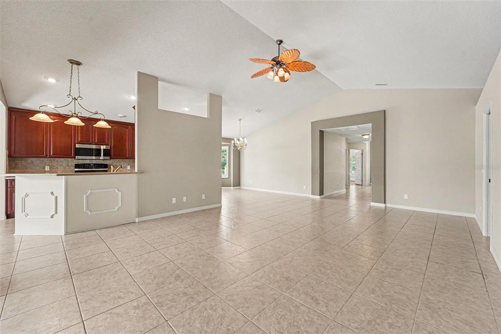 A kitchen features cherry wood cabinets, stainless steel appliances, and tan countertops — 3805 E KIWI COVE CT, HERNANDO, FL