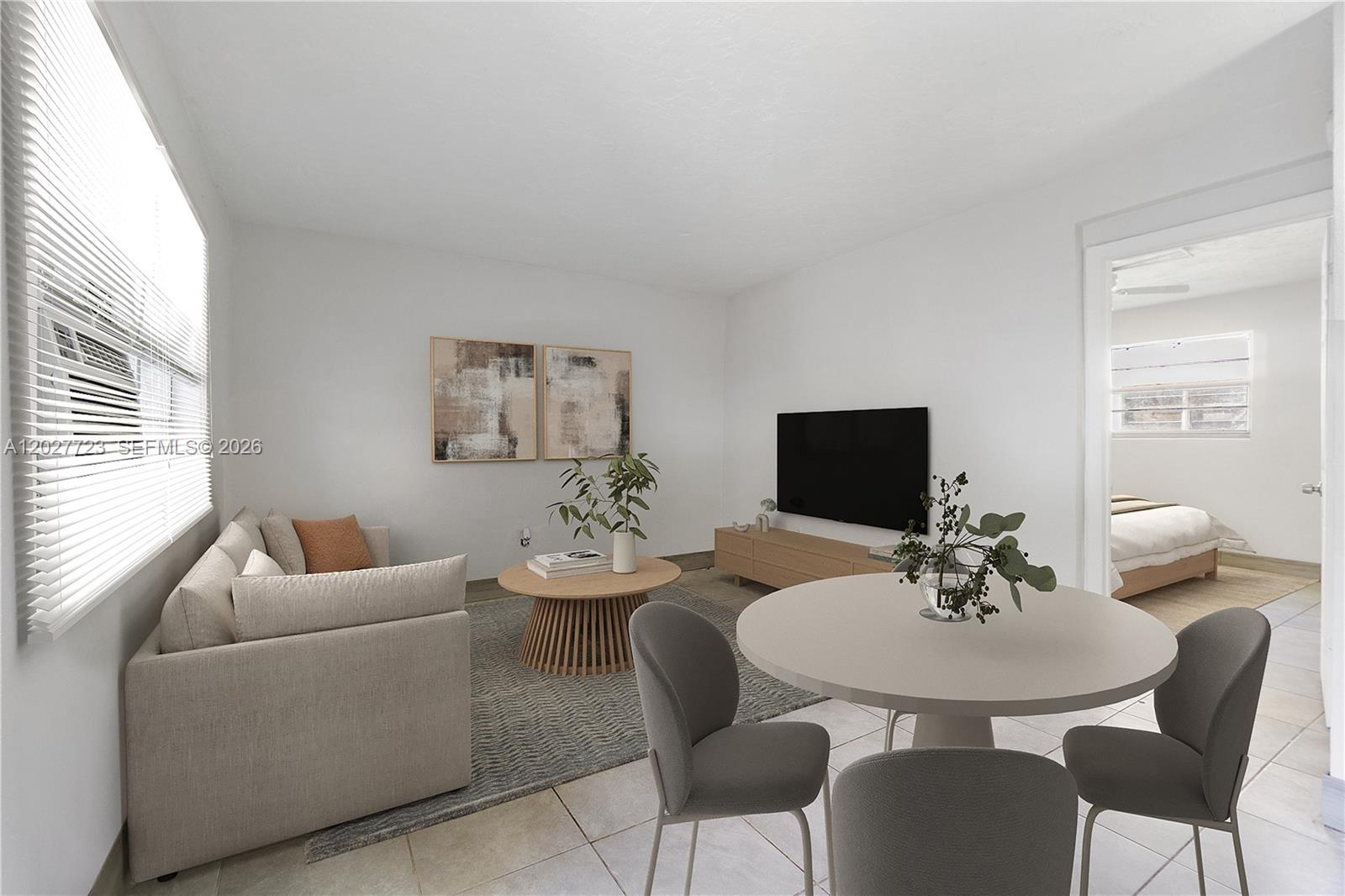 This is a living and dining room area with light-colored tile floors and white walls — 332 SW 3rd St # 5, Belle Glade FL 33430, BELLE GLADE, FL