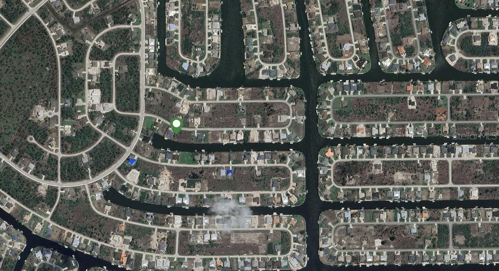 This is an aerial map view of a residential neighborhood featuring homes along canal waterways — 15340 ACORN CIRCLE, PORT CHARLOTTE, FL