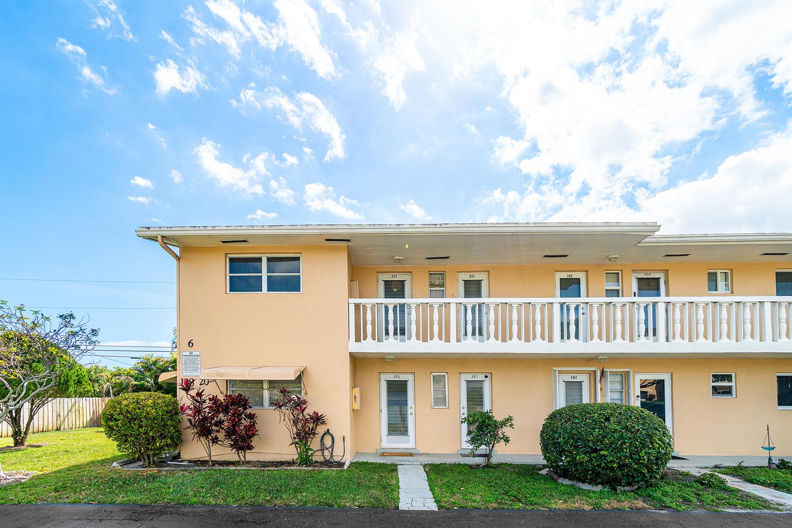 A two-story apartment building with a peach-colored exterior and a white balcony railing — 108 NE 20th Avenue NE # 201, Boynton Beach FL 33435, BOYNTON BEACH, FL