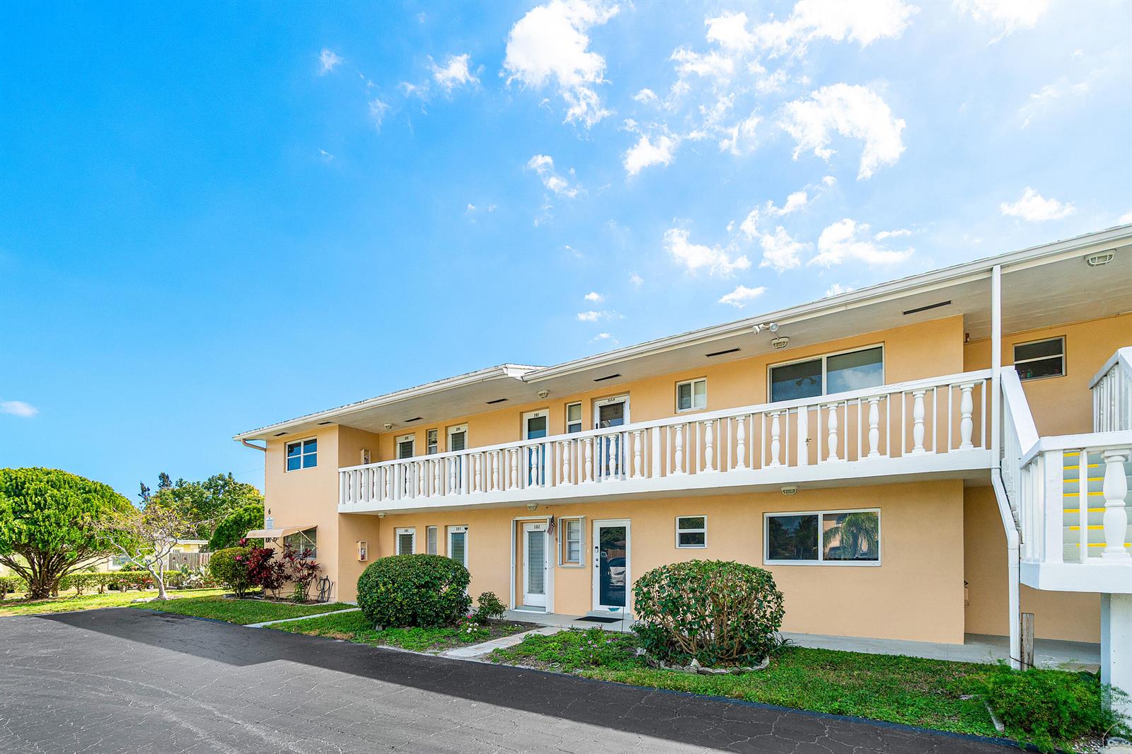 A two-story apartment building with a white balcony and tan exterior walls — 108 NE 20th Avenue NE # 201, Boynton Beach FL 33435, BOYNTON BEACH, FL