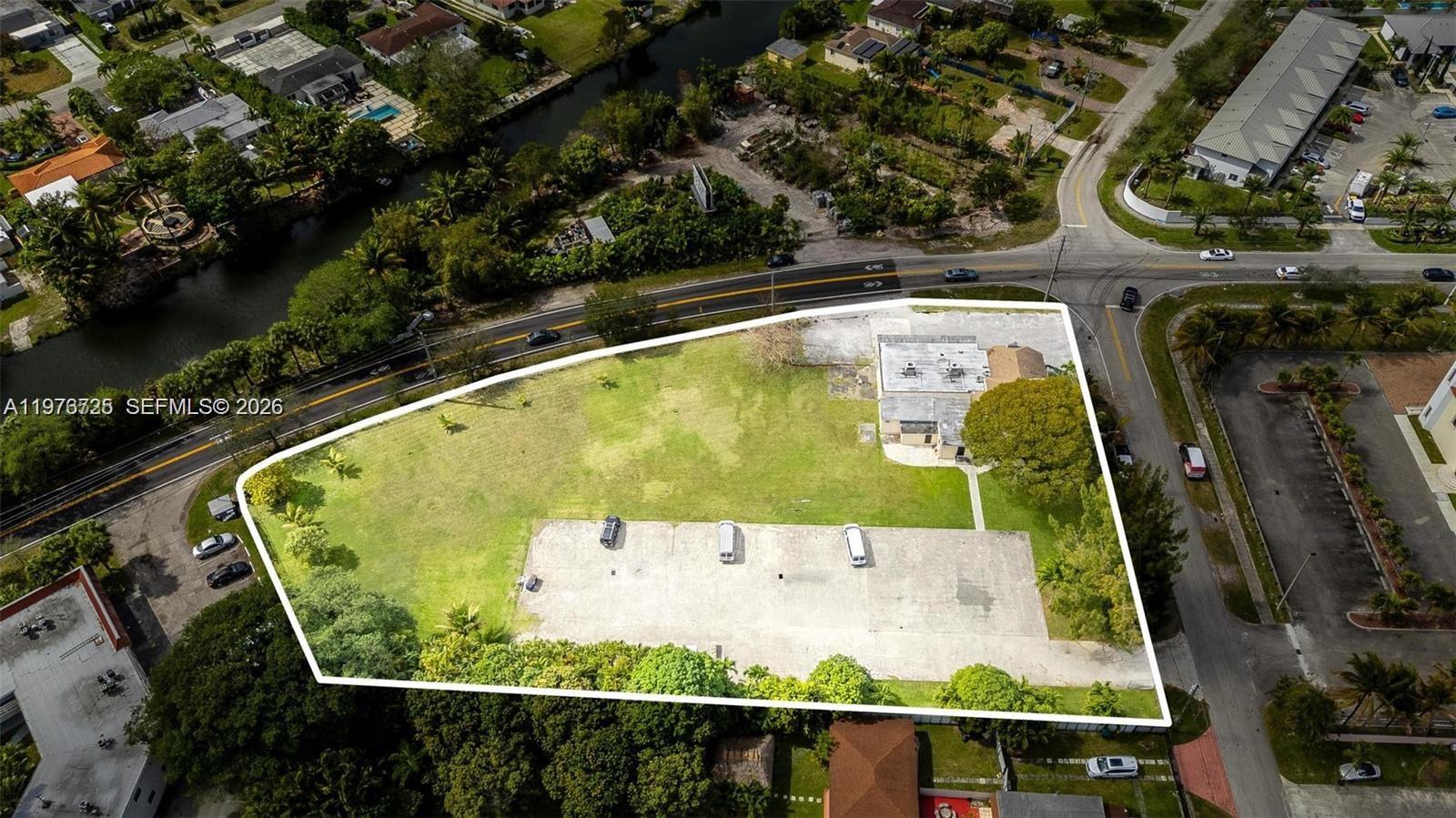 An aerial view shows a large grassy lot with a building and paved parking area — 15343 NW 2nd Ave, Miami FL 33169, MIAMI, FL