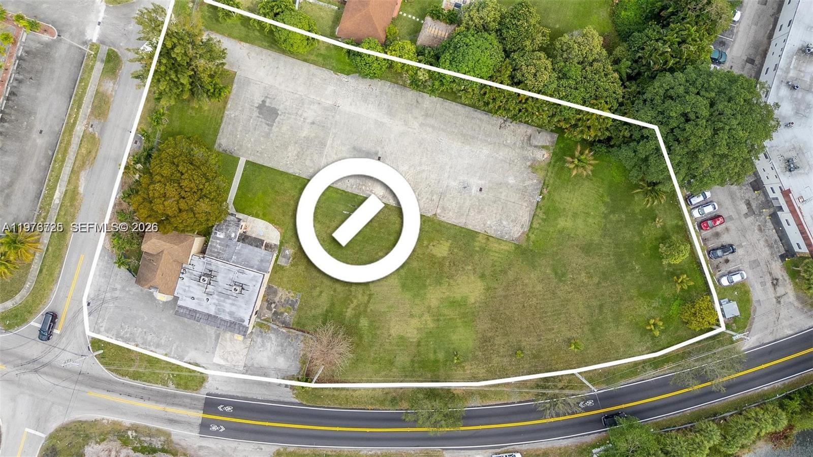 An aerial view shows a paved lot and a building on a grassy property — 15343 NW 2nd Ave, Miami FL 33169, MIAMI, FL