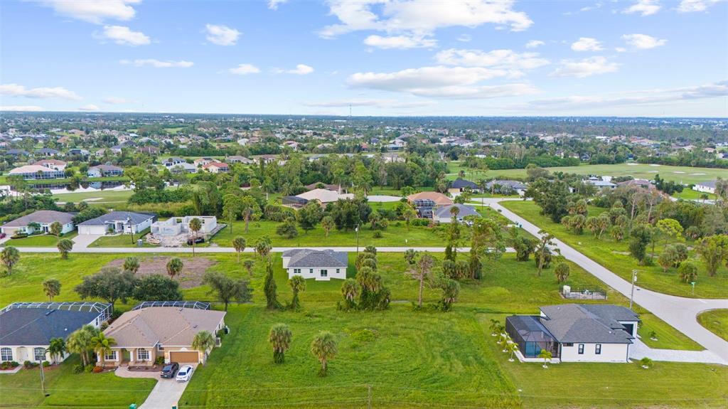 An aerial view shows several suburban houses and vacant lots in a residential neighborhood — 70 TEE VIEW ROAD, ROTONDA WEST, FL