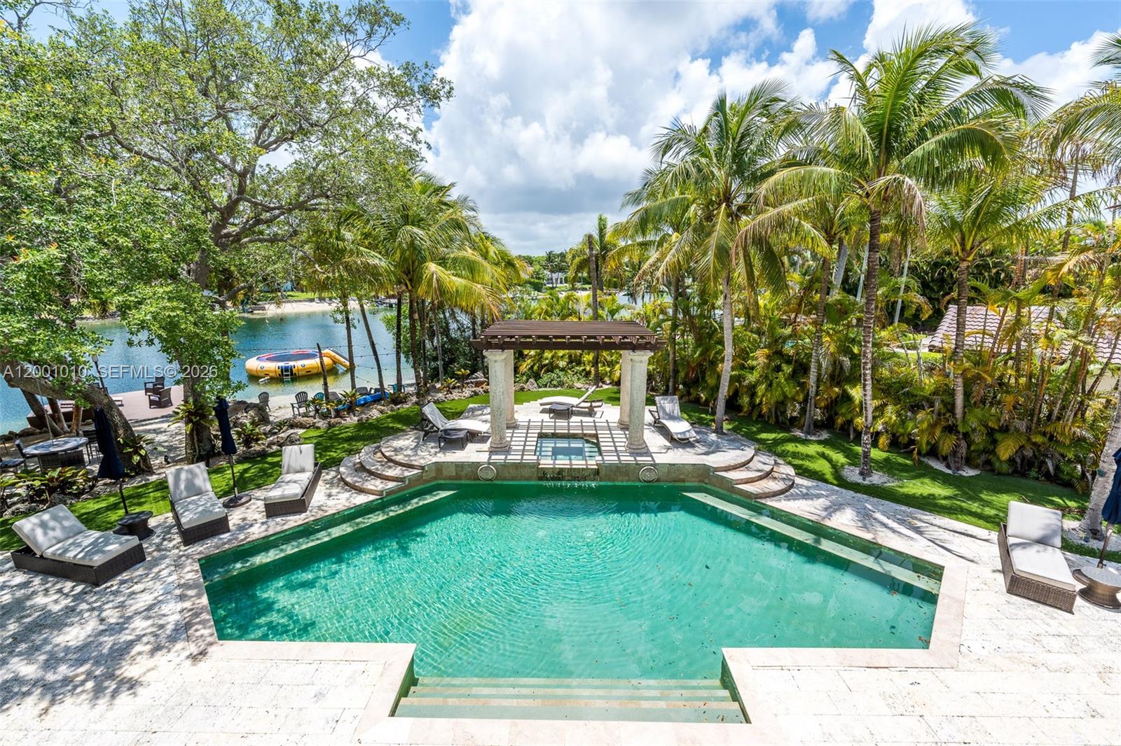 An outdoor pool area features a hexagonal pool, a stone pergola, and palm trees — 9240 SW 140th St, Miami FL 33176, MIAMI, FL