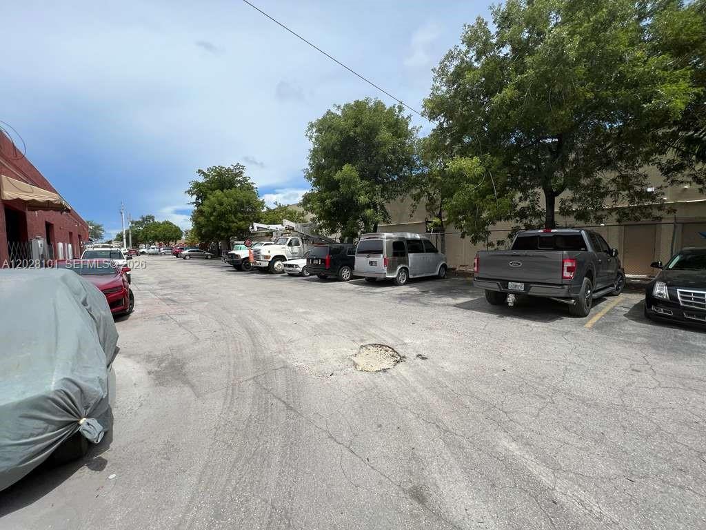 A paved parking lot with several vehicles parked in front of a commercial building — 13690 SW 142nd Ave, Miami FL 33186, MIAMI, FL