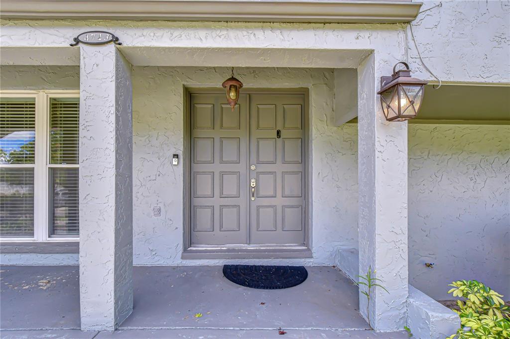 A covered entryway features a double front door, a porch light, and a house number plaque — 4723 SOUTHBREEZE DRIVE, TAMPA, FL